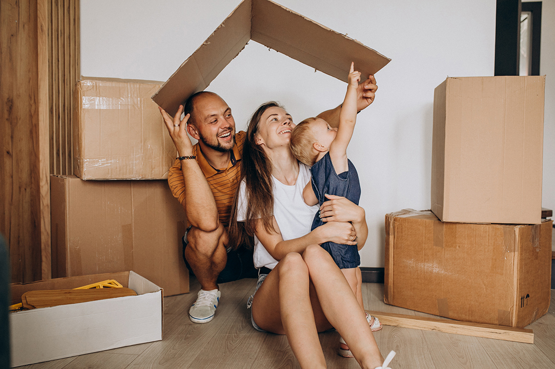 Young family with little daughter moving into new house